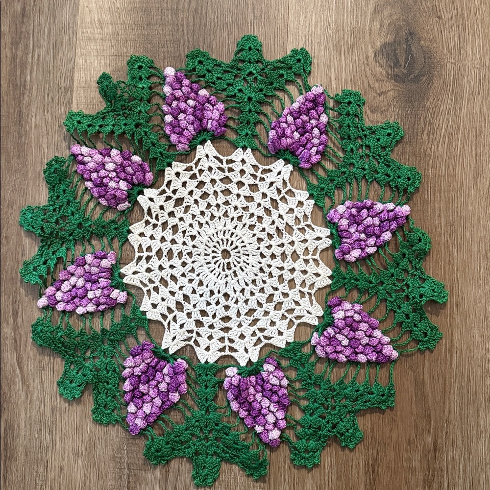 Vintage style hand-crocheted doily featuring a "grape bunch" design.